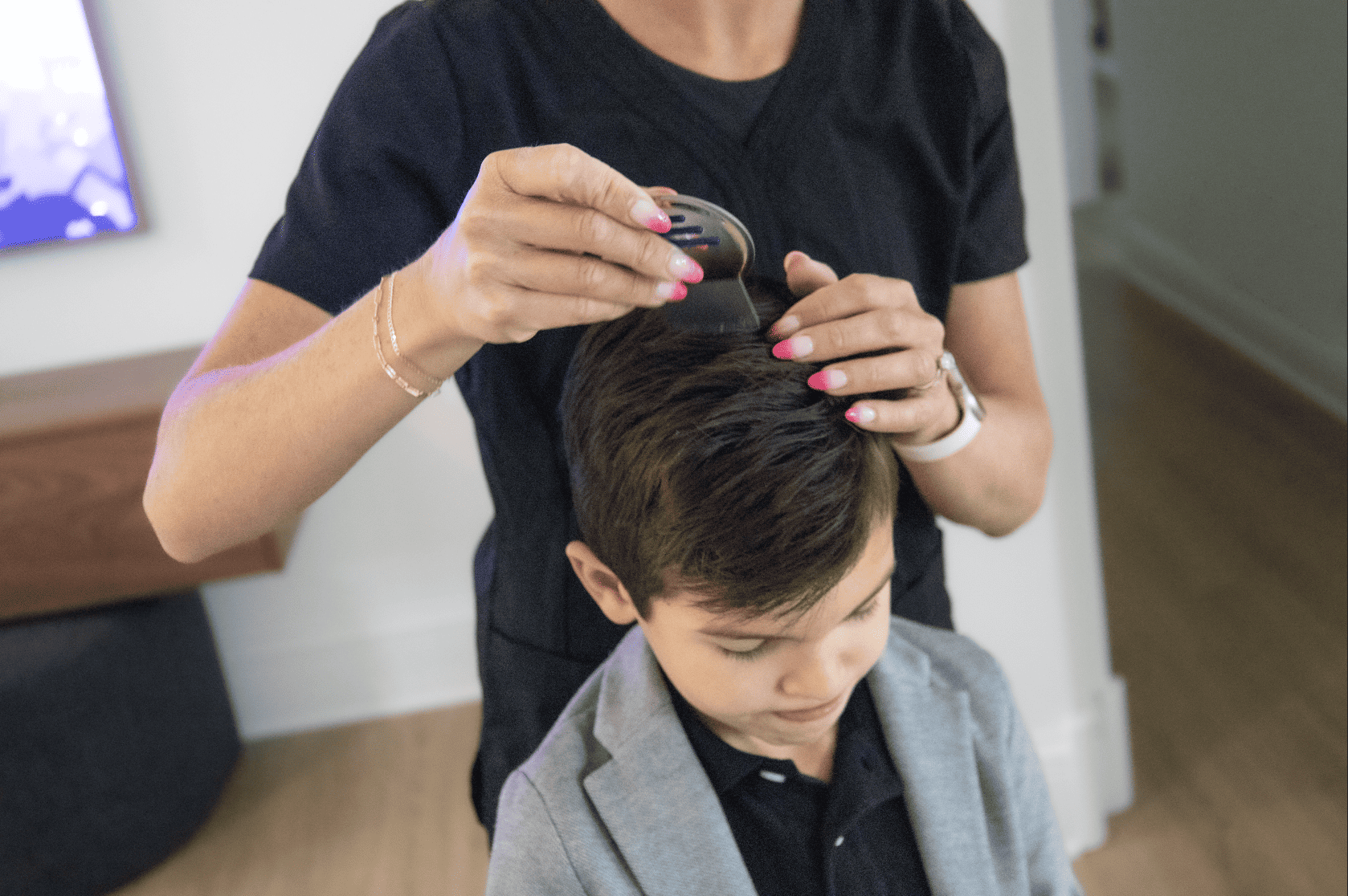 boy getting checked for lice at school